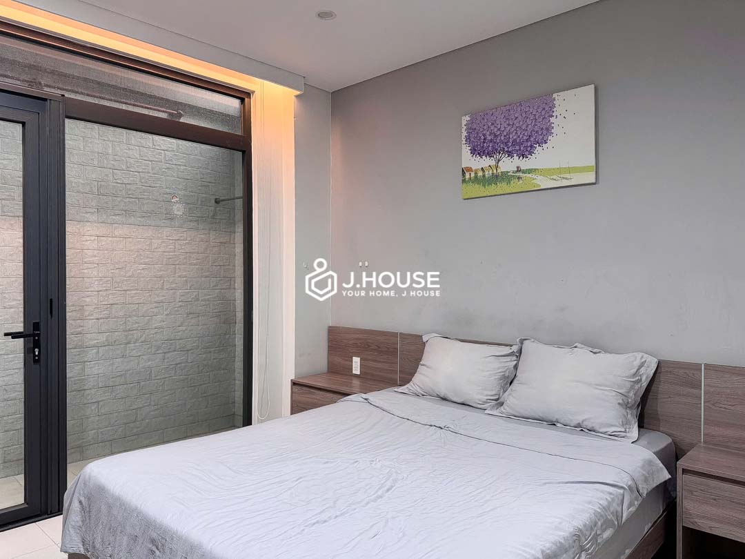 Cozy bedroom opening to skylight at KHouse District 1